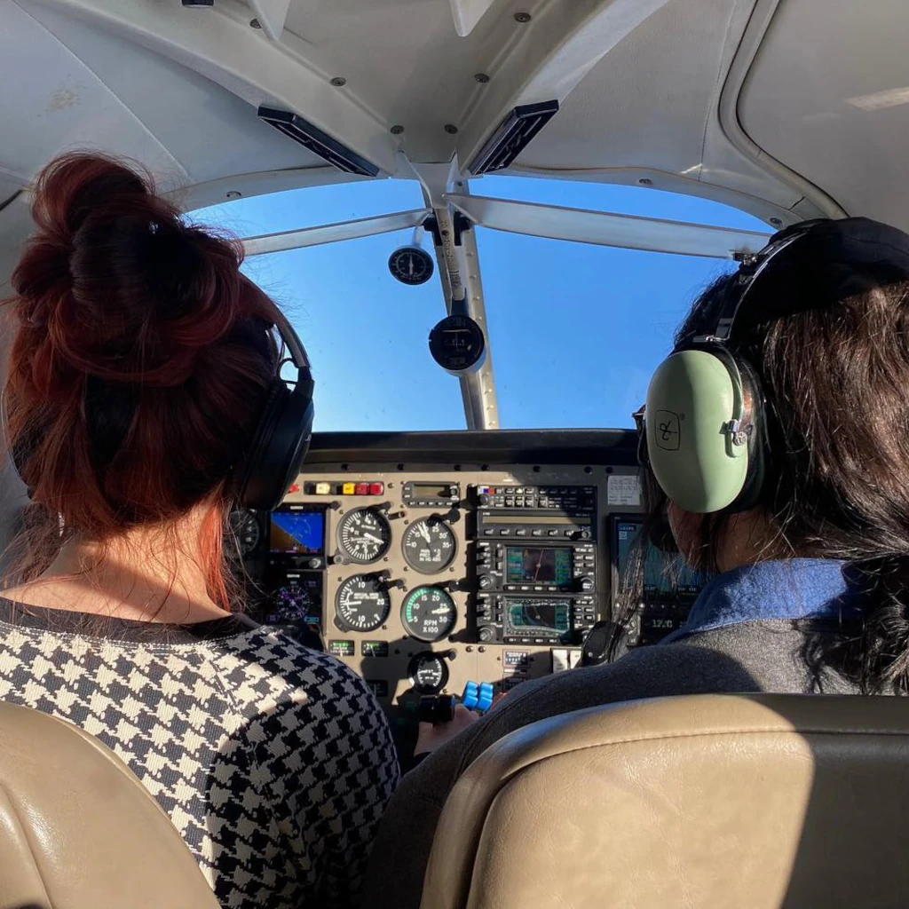 Over-the-shoulder view of pilots training in an airplane cockpit